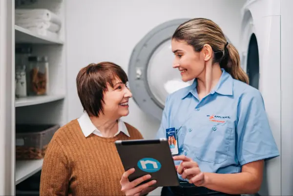 mr.appliance professional pointing at iPad and talking with woman