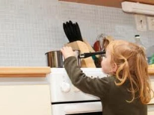 Child reaching for a hot pot