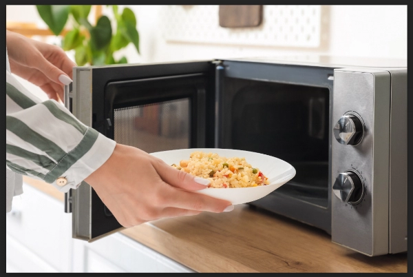 woman-putting-plate-rice-vegetables