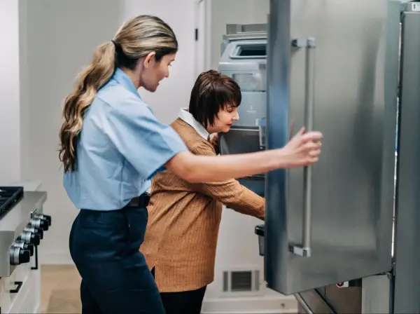 Mr. Appliance professional opening a fridge