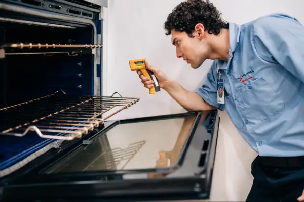 Mr. Appliance professional checking oven temperature